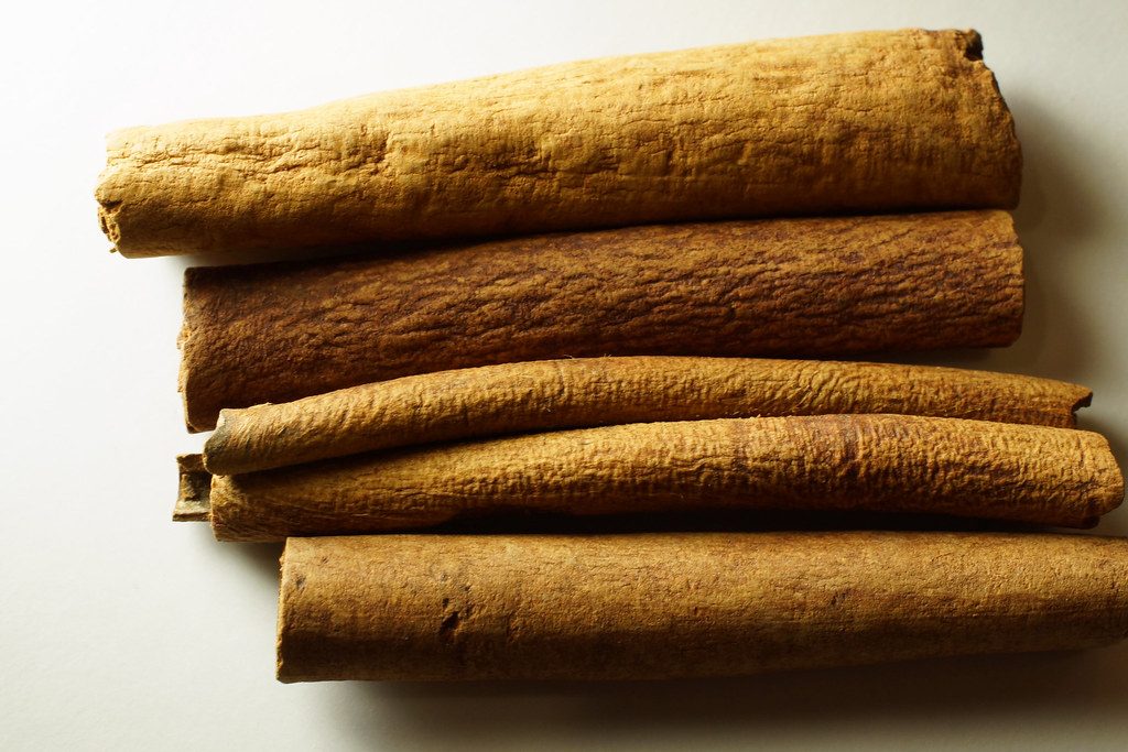 Cinnamon sticks arranged on a wooden surface