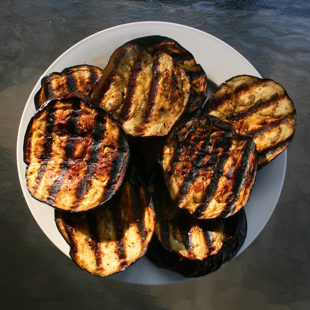 A Mediterranean spread with grilled vegetables on a plate