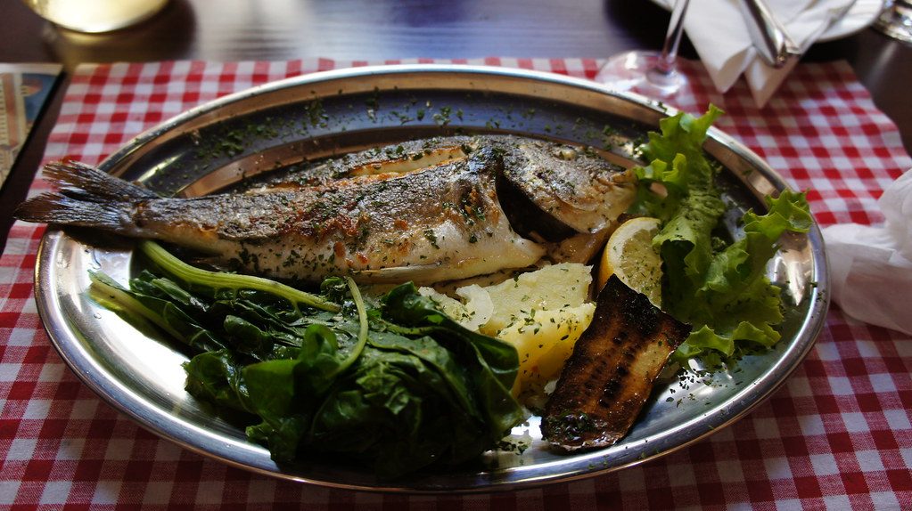Grilled fish served with vegetables in a Mediterranean style